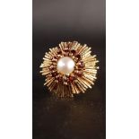 1970s GARNET AND PEARL DRESS RING the central pearl in garnet surround and starburst effect setting,