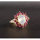 RUBY AND MOONSTONE CLUSTER RING the central oval cabochon moonstone in sixteen ruby surround, on