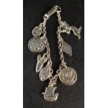 UNUSUAL CELTIC SILVER CHARM BRACELET with two Iona silver charms by Iain MacCormick, one with