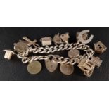 GOOD SILVER CHARM BRACELET with various charms including several articulated examples, including a