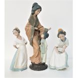 THREE NAO FIGURINES depicting a Japanese mother and her daughter, 38cm high, and two young girls,