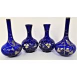 TWO PAIRS OF BRISTOL BLUE STYLE DECANTERS both pairs over painted with flowers and leaves, one