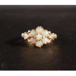 OPAL CLUSTER RING the round cabochon opals on nine carat gold shank with decorative shoulders,