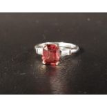 UNUSUAL ORANGE SAPPHIRE AND DIAMOND RING the emerald cut sapphire approximately 2.4cts, flanked by