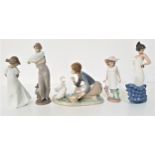 LLADRO FIGURINE depicting a young girl feeding ducks, 23cm long and four Nao figurines - male