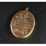 NINE CARAT GOLD OVAL LOCKET PENDANT the front with floral decoration and white gold highlights, 4.