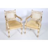 A PAIR OF REGENCY DESIGN POLYCHROME PARCEL GILT AND UPHOLSTERED ELBOW CHAIRS each with a pierced top
