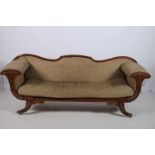 A REGENCY MOHAGANY AND UPHOLSTERED SETTEE the serpentine top rail above an upholstered panel with