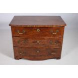 A CONTINENTAL WALNUT CROSS BANDED CHEST of rectangular bowed outline with three long graduated
