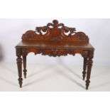 A 19TH CENTURY GOTHIC DESIGN OAK SIDE TABLE of rectangular outline the carved back and frieze