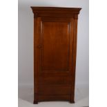 A CHERRYWOOD CUPBOARD the outswept moulded cornice above a panelled door containing adjustable