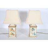 A PAIR OF CONTINENTAL POTTERY TABLE LAMPS BY JOHN WRIGHT the cream and gilt ground decorated with