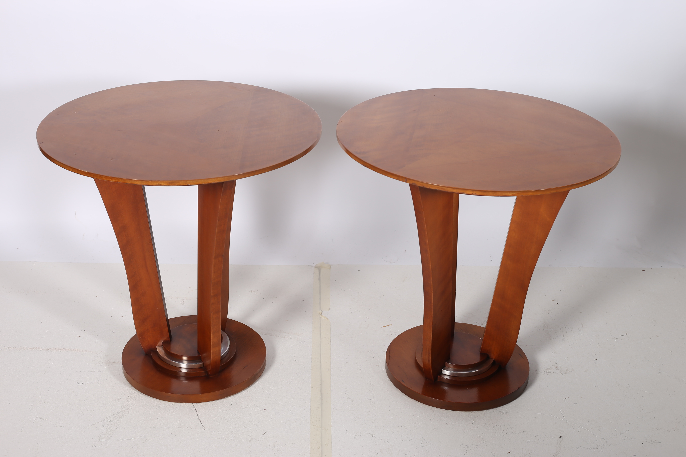 A PAIR OF CONTEMPORARY CHERRYWOOD LAMP TABLES each of circular form raised on a shaped support on