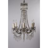 A CONTINENTAL GILT BRASS AND CUT GLASS SIX BRANCH CHANDELIER hung with faceted chains and pendent