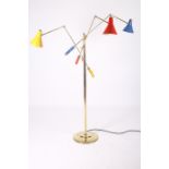 A TRIENNALE FLOOR STANDING LAMP Italian on circular base the brass column and adjustable arms with