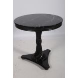 A CONTINENTAL EBONISED AND MARBLE CENTRE TABLE the circular black veined marble top above a fluted