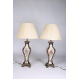 A PAIR OF CONTINENTAL PORCELAIN AND GILT BRASS TABLE LAMPS the white blue and gilt ground with