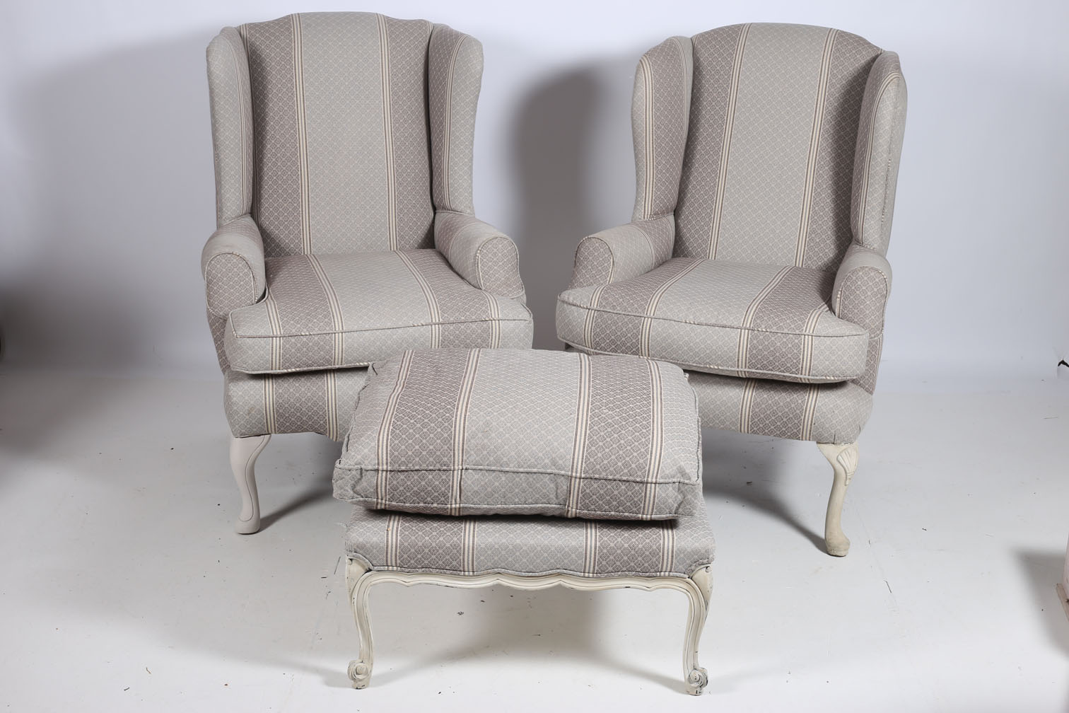A PAIR OF QUEEN ANNE DESIGN GREY PAINTED AND UPHOLSTERED WING CHAIRS with scroll over arms and loose