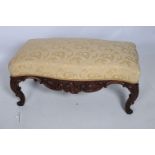 A FINE 19TH CENTURY CARVED MAHOGANY AND UPHOLSTERED STOOL the serpentine upholstered seat above a
