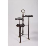 AN EDWARDIAN MAHOGANY AND BRASS THREE TIER CAKE STAND each circular dish raised on cylindrical leg