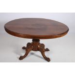 AN EDWARDIAN MAHOGANY INLAID POD TABLE the oval top above a carved column on quadruped splayed