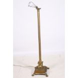 A BRASS CORINTHIAN COLUMN FLOOR STANDING LAMP the reeded column above a stepped base on claw and