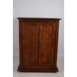 A CONTINENTAL OAK CUPBOARD of rectangular outline with panelled doors the interior shelved unit