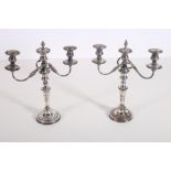 A PAIR OF 19TH CENTURY SILVER PLATED AND COPPER THREE BRANCH CANDELABRA the scroll arms above a