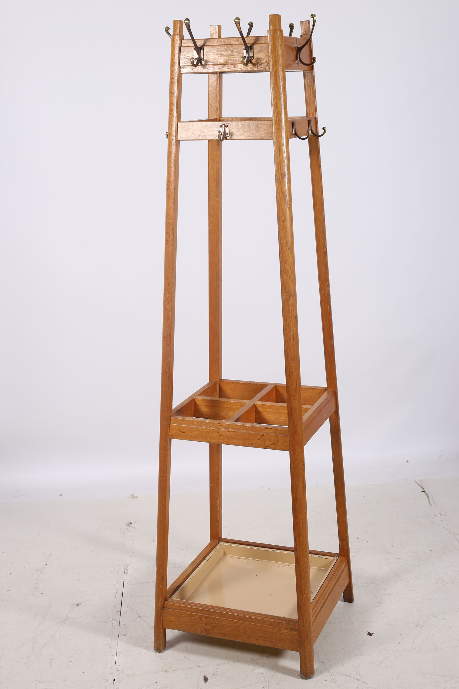 A CIRCA 1950s BLEACHED OAK HAT COAT AND STICK STAND of rectangular spreading form with four open