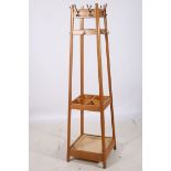 A CIRCA 1950s BLEACHED OAK HAT COAT AND STICK STAND of rectangular spreading form with four open