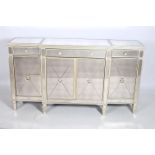 A CONTEMPORARY CONTINENTAL SILVERED AND MIRRORED SIDE CABINET of rectangular bowed outline with