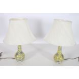 A PAIR OF ORIENTAL PORCELAIN TABLE LAMPS each with a yellow ground decorated with flowerheads and