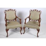 A PAIR OF CONTINENTAL STAINED WOOD AND UPHOLSTERED ELBOW CHAIRS each with a serpentine pierced top