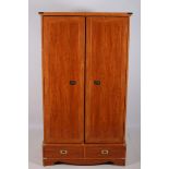 A MAPLE WOOD AND BRASS BOUND WARDROBE the moulded cornice above a pair of panelled doors