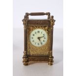 A 19TH CENTURY FRENCH BRASS CARRIAGE CLOCK of rectangular form with filigree case and fluted columns