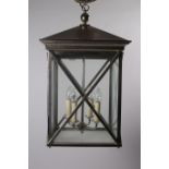 A WHITE METAL AND GLAZED FOUR LIGHT HALL LANTERN of square form with diamond shaped panels 90cm x