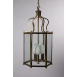 A BRASS THREE LIGHT HALL LANTERN of octagonal outline with glazed panels 48cm (h) x 27cm (w) x