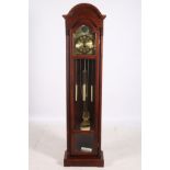 A STAINED BEECHWOOD LONG CASE CLOCK the arched pediment above a glazed door containing brass dial