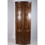A CHERRYWOOD CORNER CUPBOARD the moulded cornice above a pair of panelled doors with shelved