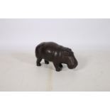 A HIDE UPHOLSTERED FOOTSTOOL in the form of a Rhino shown standing 30cm (h) x 53cm (w)