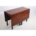 A GEORGIAN MAHOGANY DROP LEAF TABLE the rectangular hinged top raised on square moulded legs 73cm (