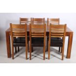 A SEVEN PIECE HARDWOOD DINING ROOM SUITE comprising six ladder back chairs with upholstered seats on
