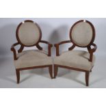 A PAIR OF CONTINENTAL HARDWOOD AND UPHOLSTERED ARMCHAIRS each with an oval upholstered panel and