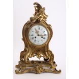 A Beaux Arts ormolu mantle clock surmounted by an amorino