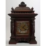 A Beaux Arts carved walnut mantle clock