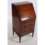 AN EDWARDIAN MAHOGANY AND SATINWOOD INLAID BUREAU the hinged writing slope with tooled leather inset