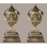 A VERY FINE AND IMPRESSIVE PAIR OF SANDSTONE URNS each of ovoid tapering form hung with ribbon
