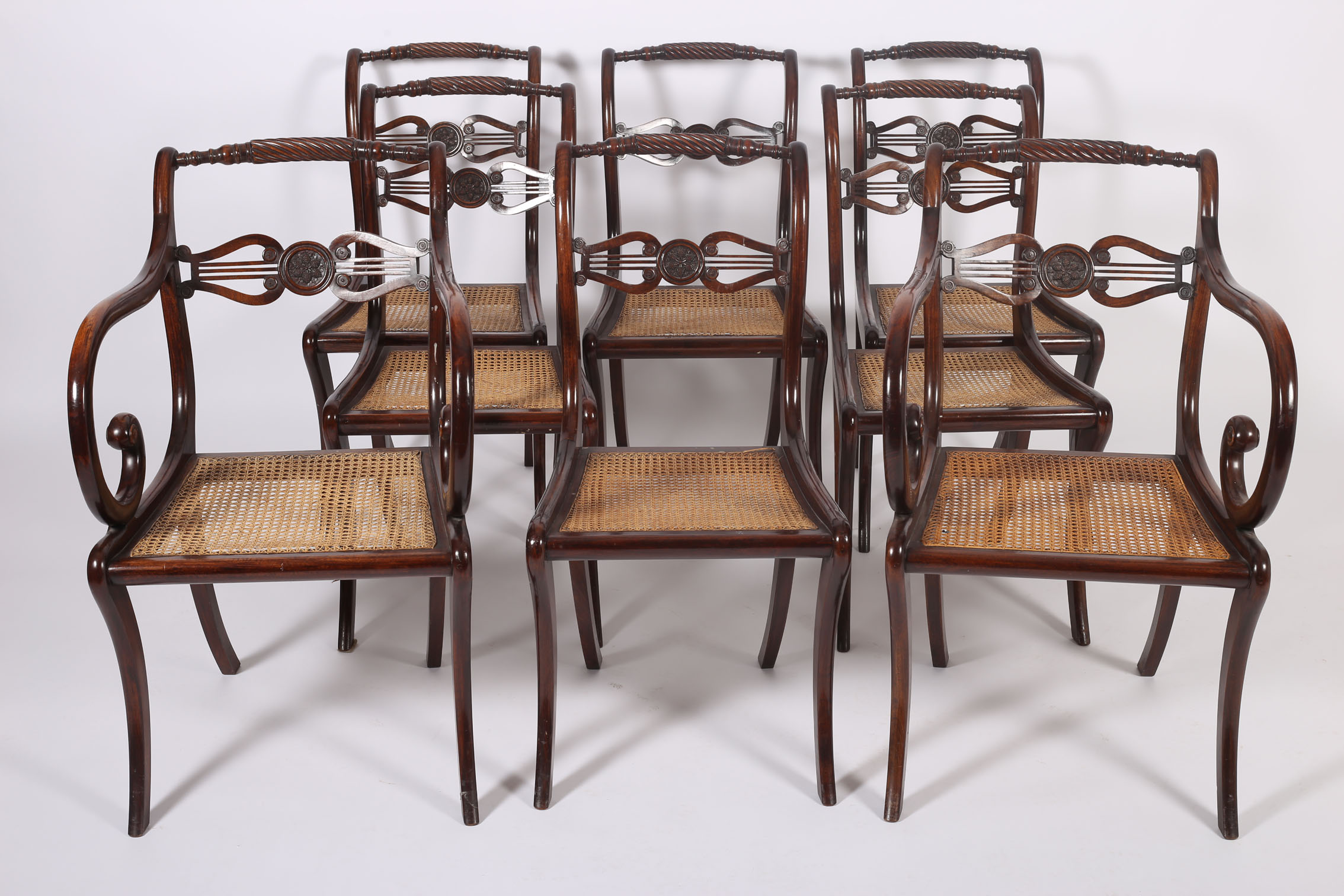 A FINE SET OF REGENCY DESIGN ROSEWOOD DINING CHAIRS Circa 1900 including a pair of elbow chairs each