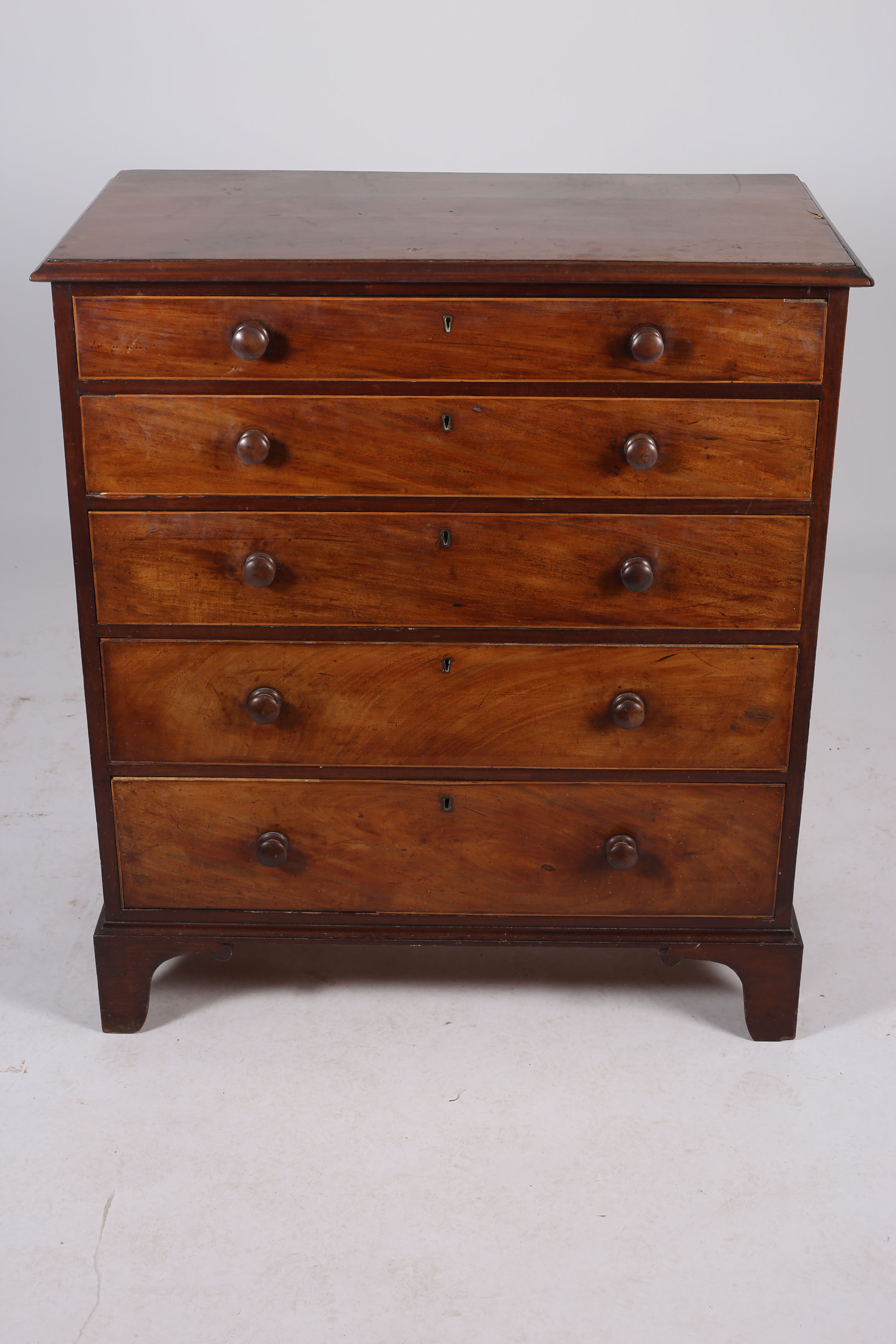 A GEORGIAN MAHOGANY CHEST of rectangular outline the shaped top above five long graduated drawers