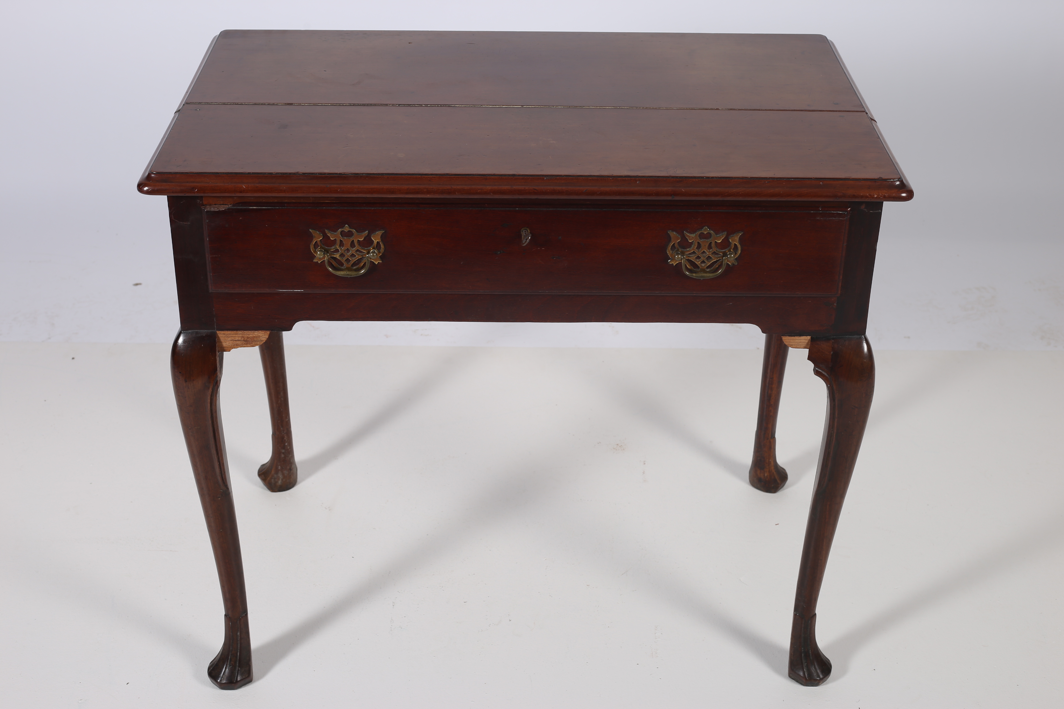 AN IRISH GEORGIAN MAHOGANY TABLE of rectangular outline with frieze drawer on cabriole legs with pad